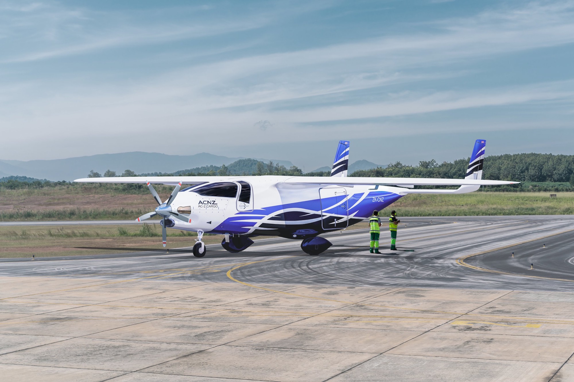 AC-2 AveniQ all-composite regional cargo aircraft, registration ZK-CNZ, on the apron with ground crew